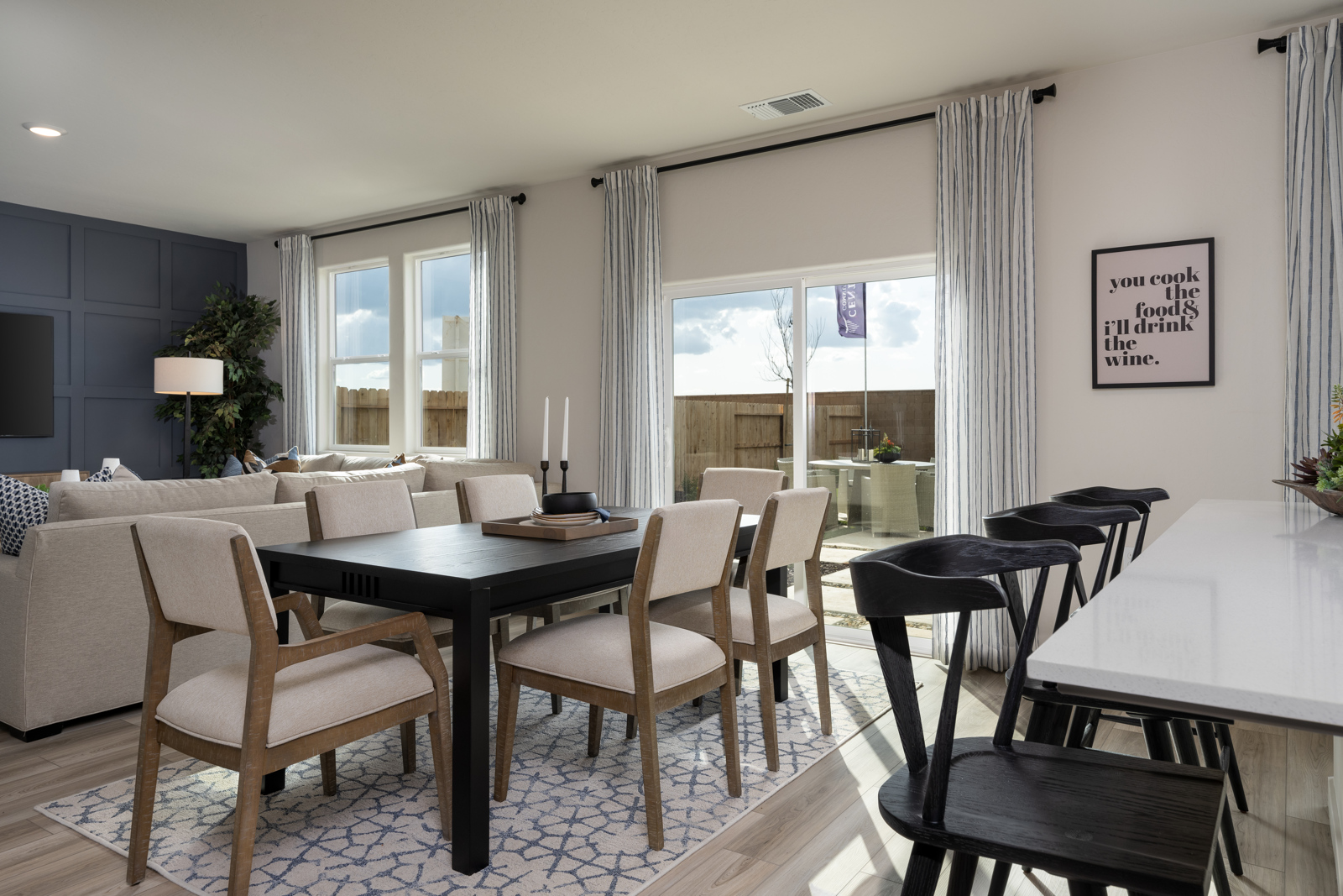 A dining room with a table and chairs.