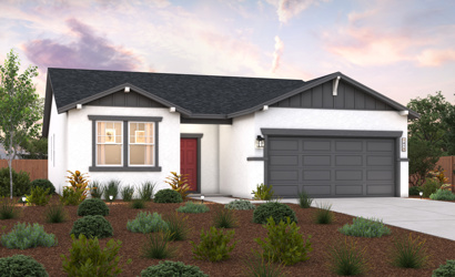 A house with a garage and bushes in front of it.