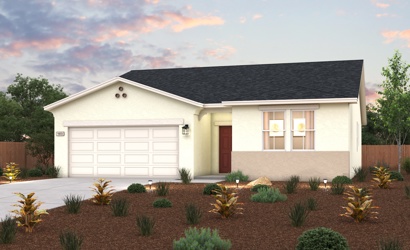 A house with a garage and bushes.