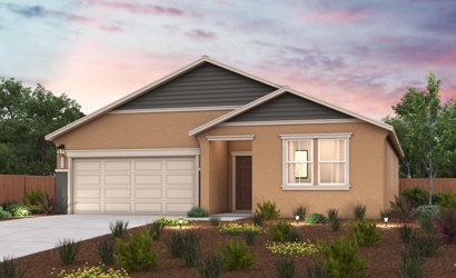 A house with a garage and a garden in front of it.