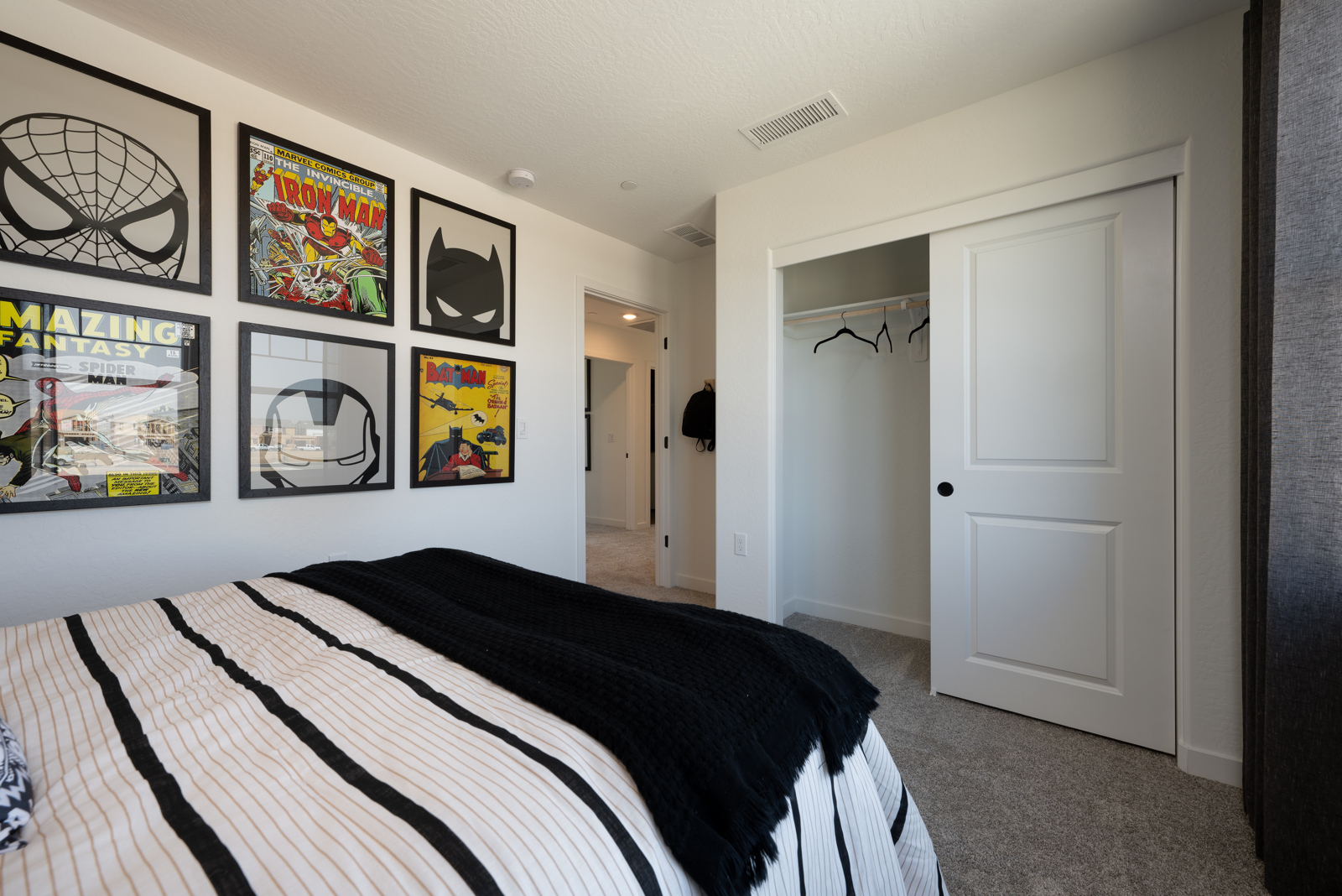 A bedroom with a bed and a white door.