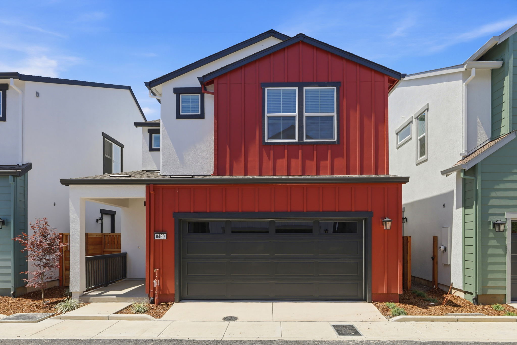 A red garage in a row of buildings.