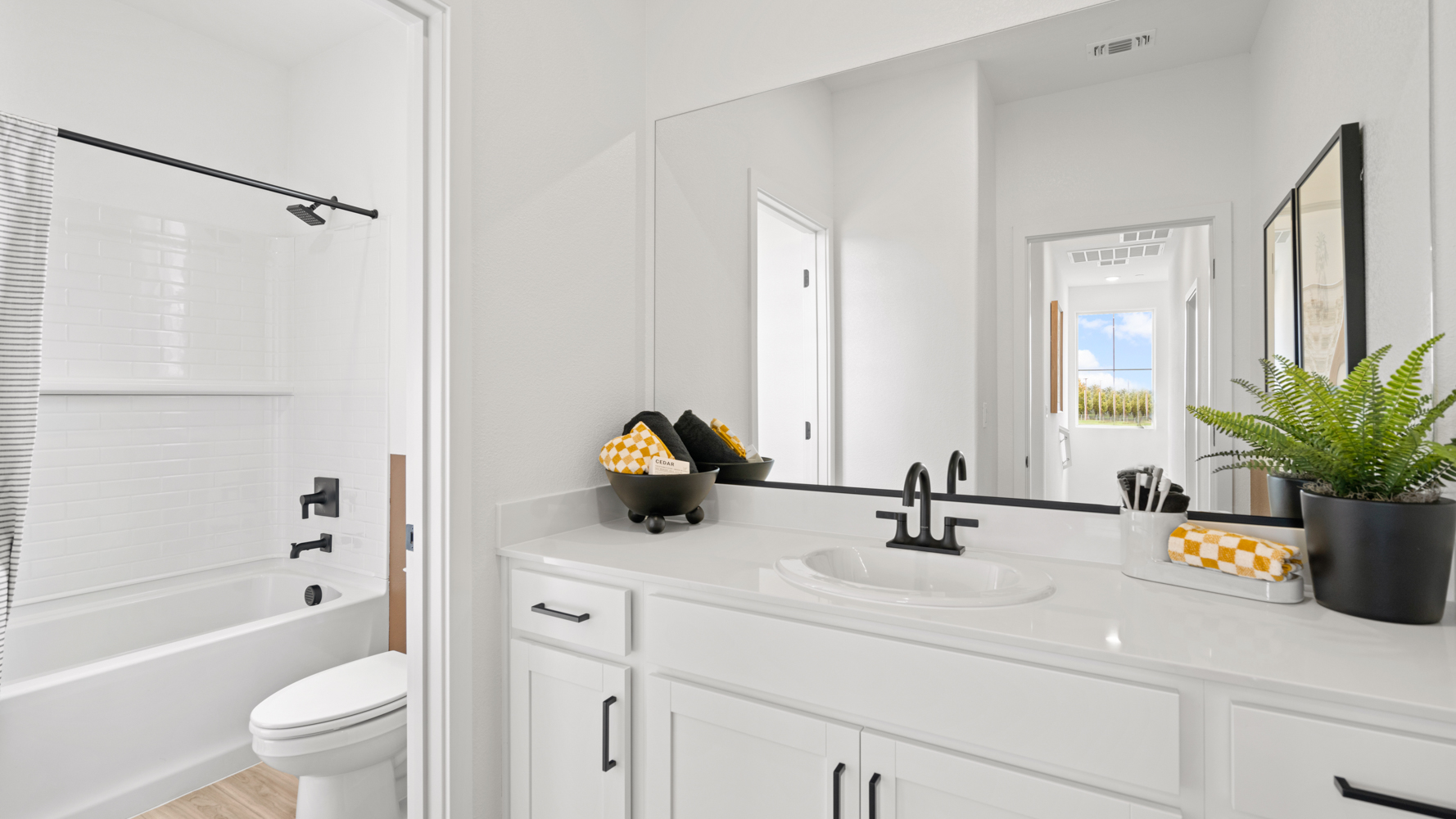 A bathroom with a tub sink and toilet.