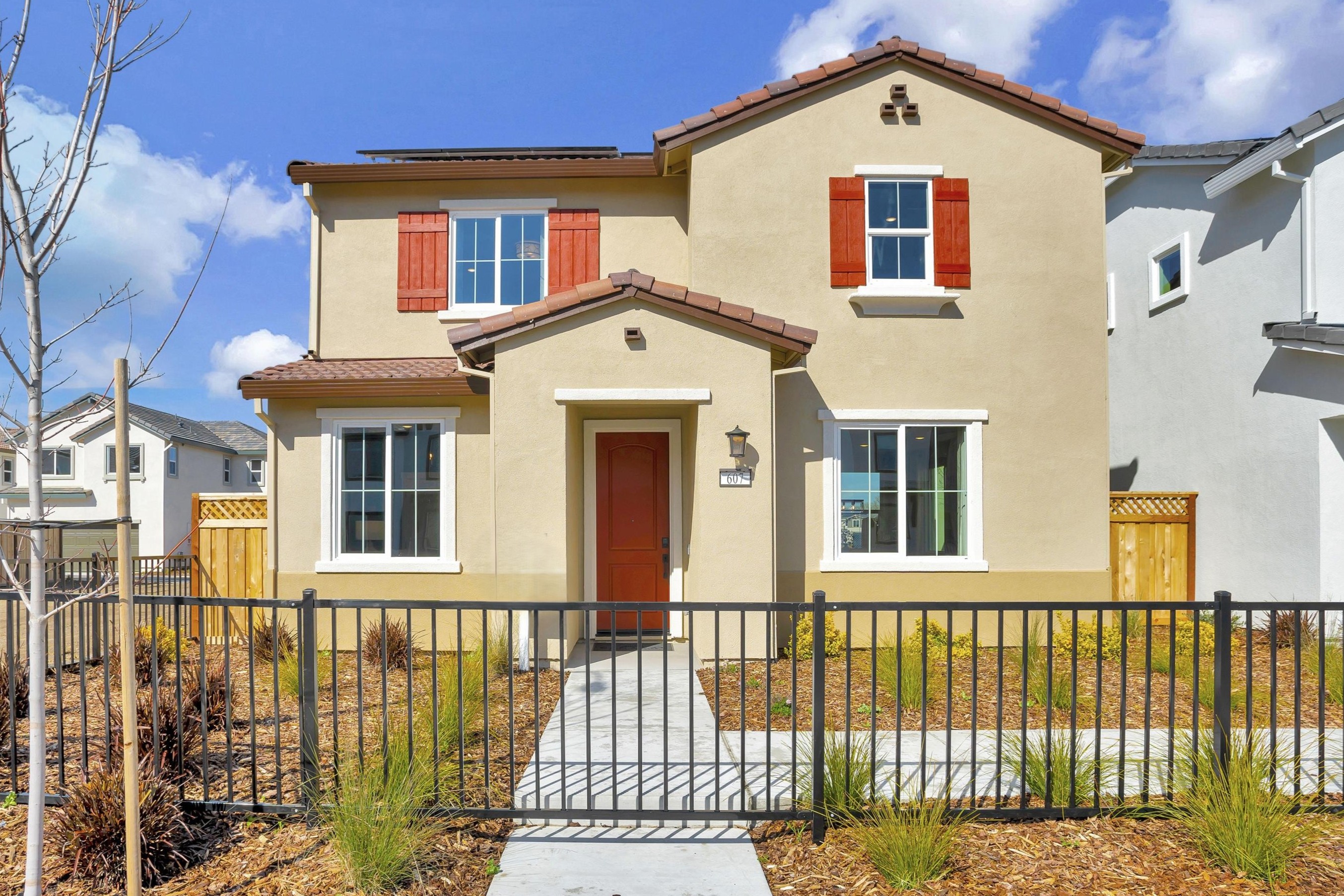 A white house with red shutters.