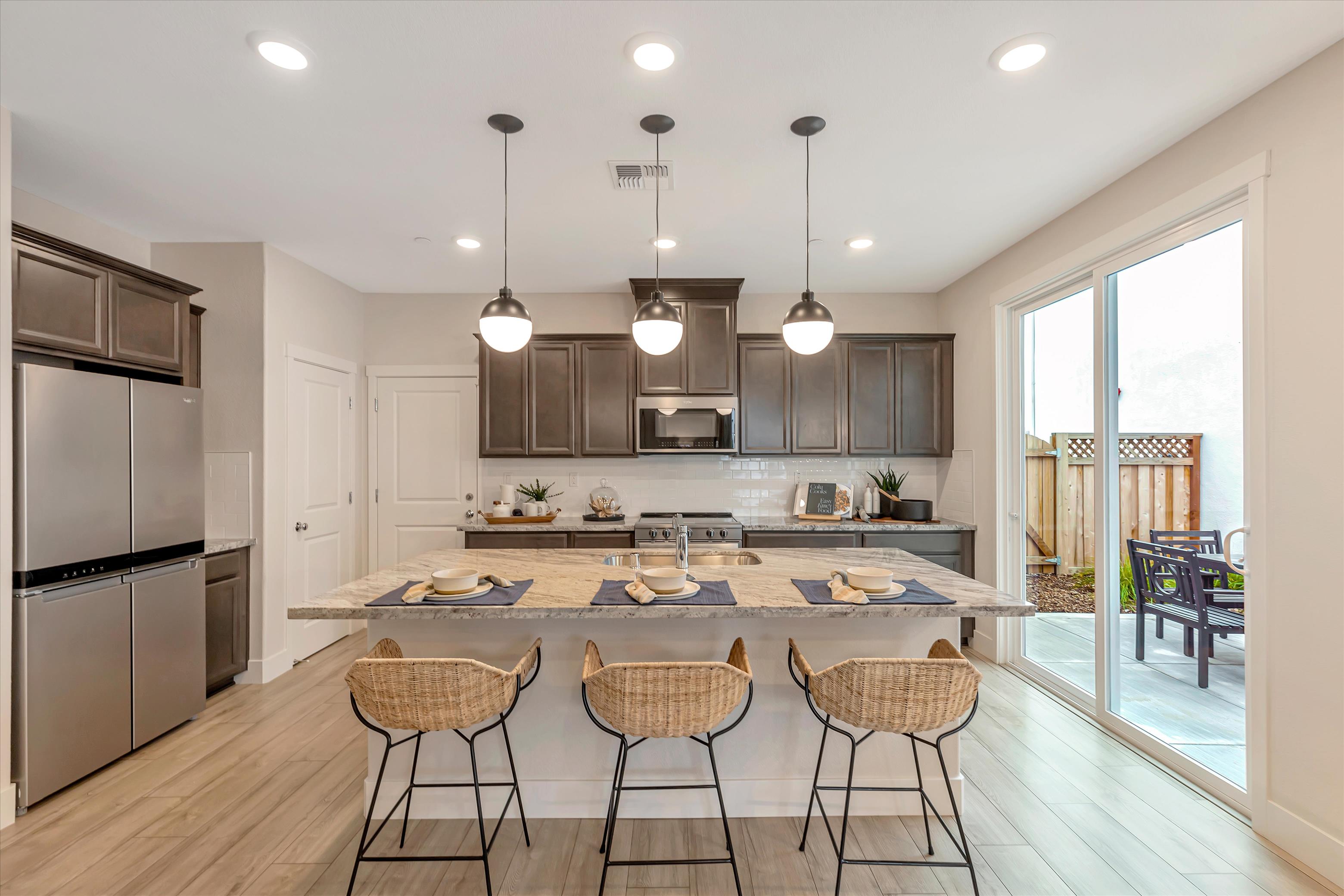 A kitchen with a bar and island.