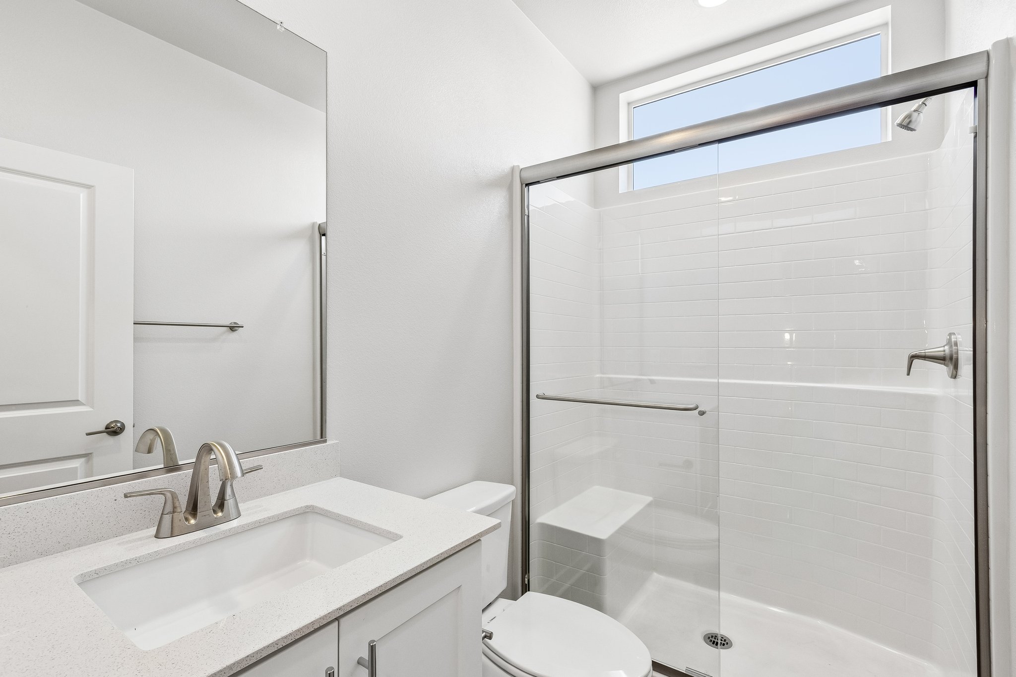 A bathroom with a glass shower.