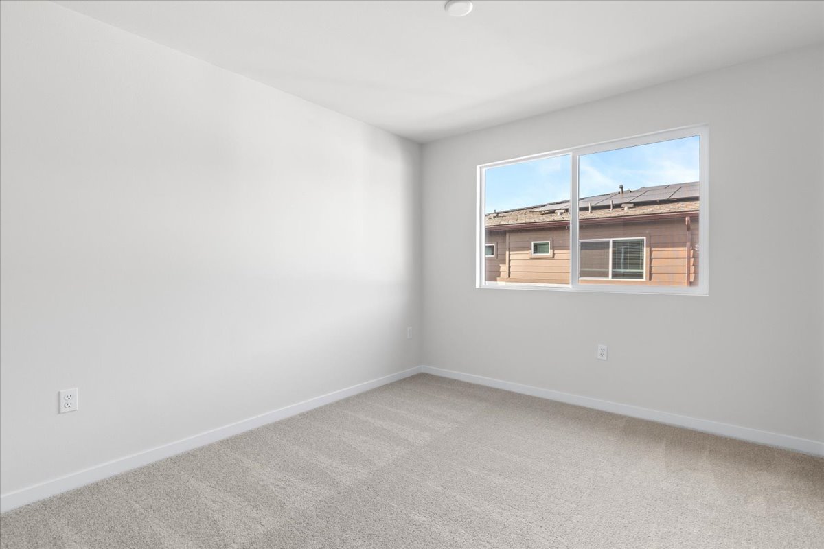 A room with a window and a carpet.