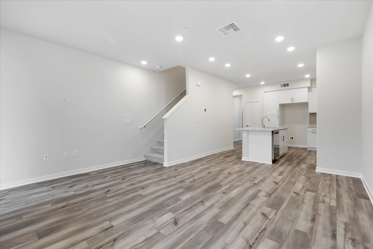 A room with white walls and wood floors.