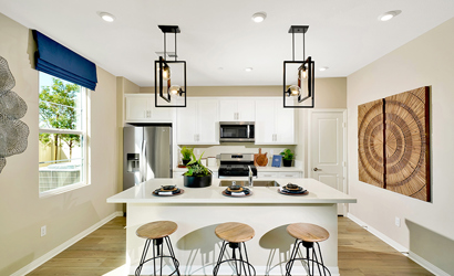 A kitchen with a table and stools.