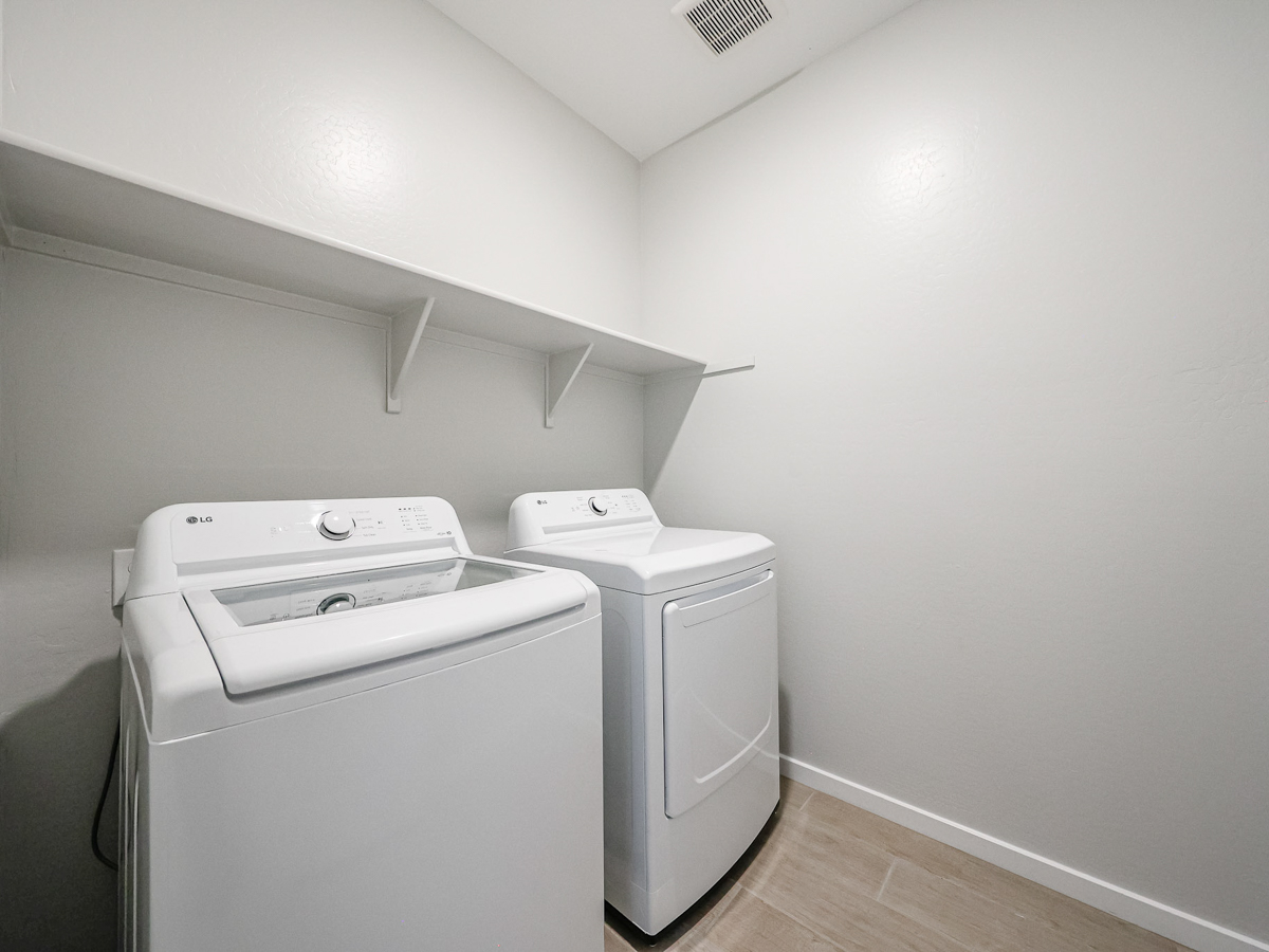A washing machine in a room.