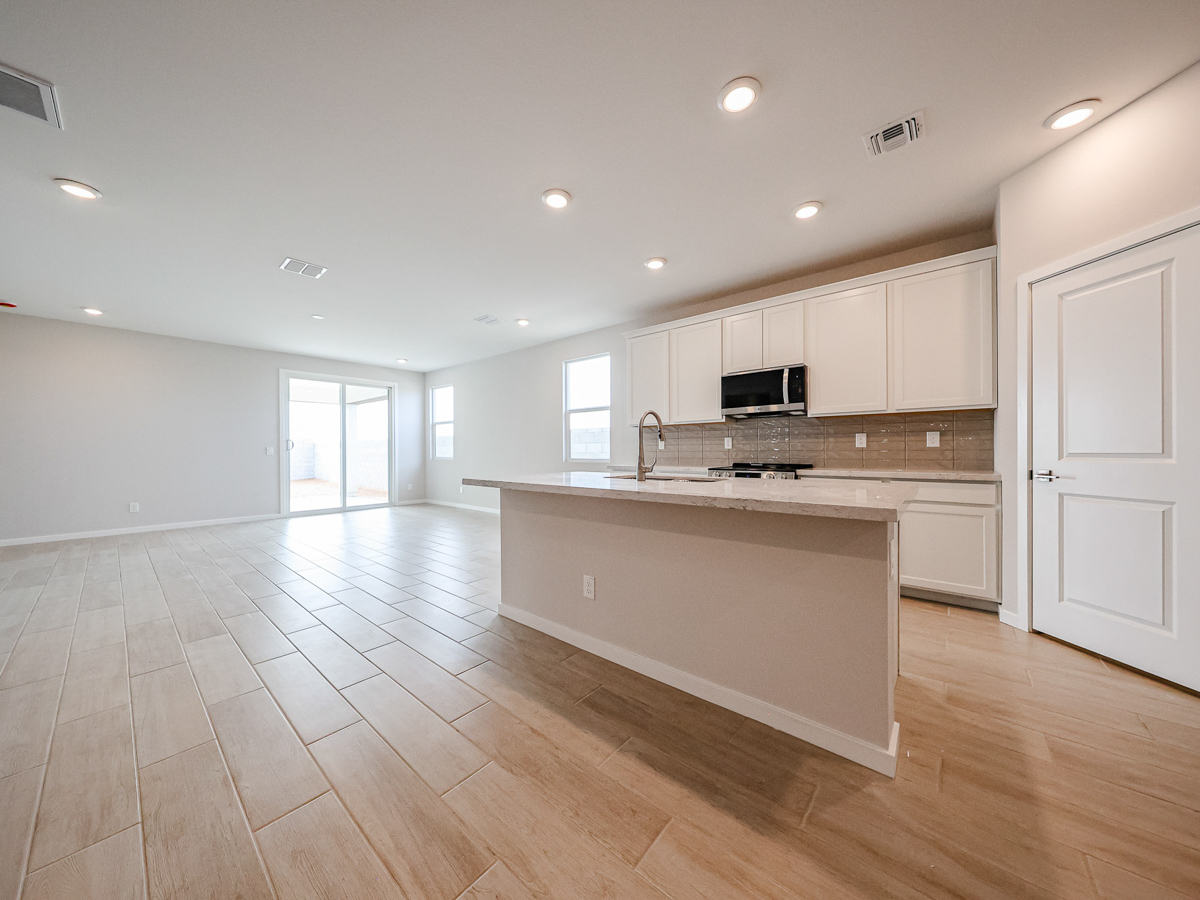 A kitchen with white cabinets.