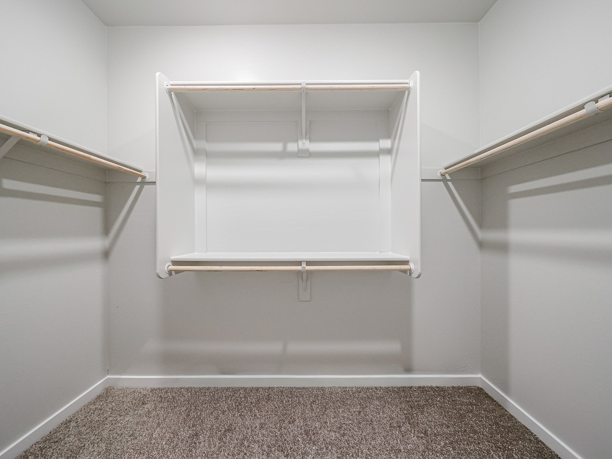 A white wall with a metal bar.