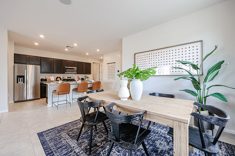 A dining room with a table and chairs.