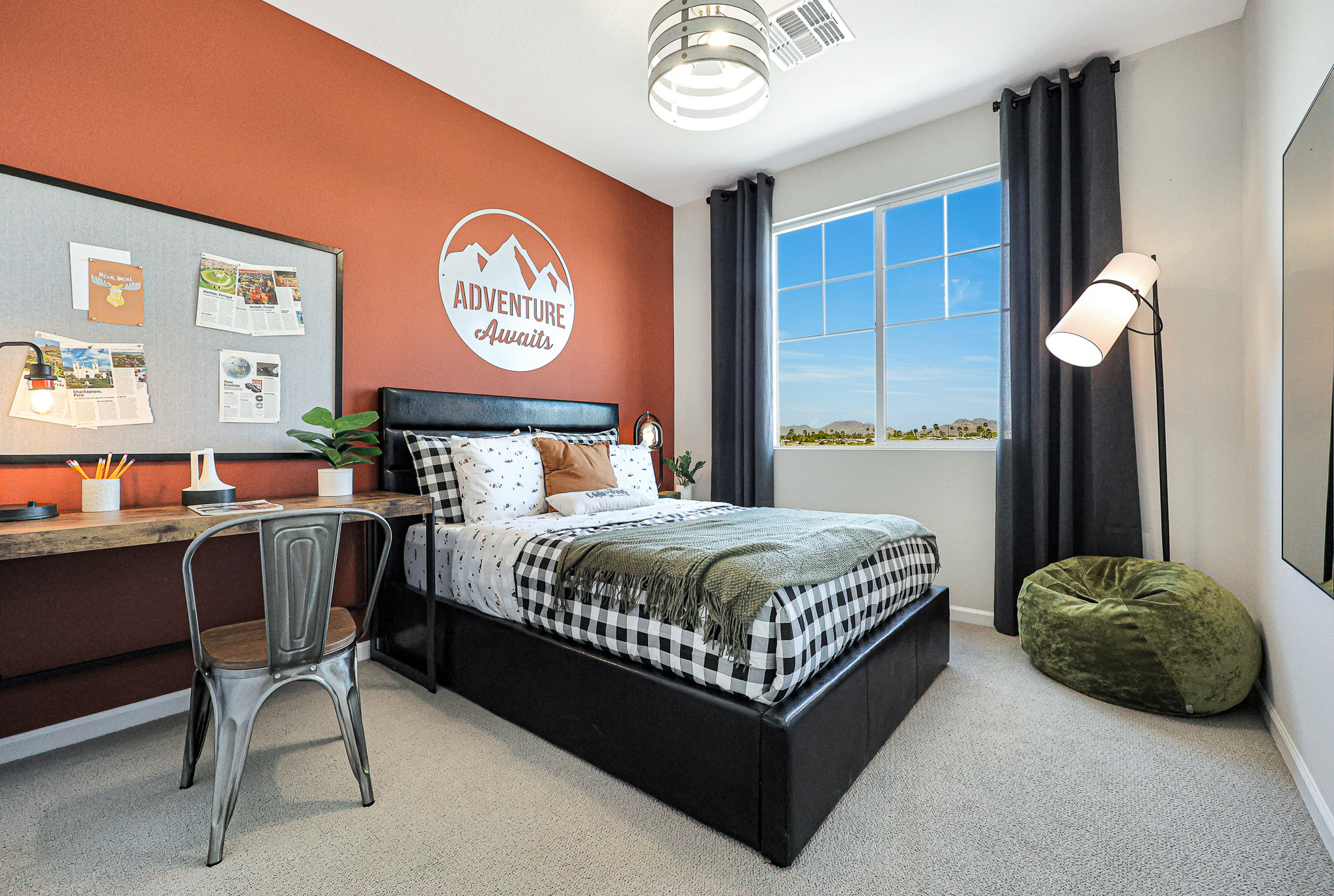 A bedroom with a bed and a desk.