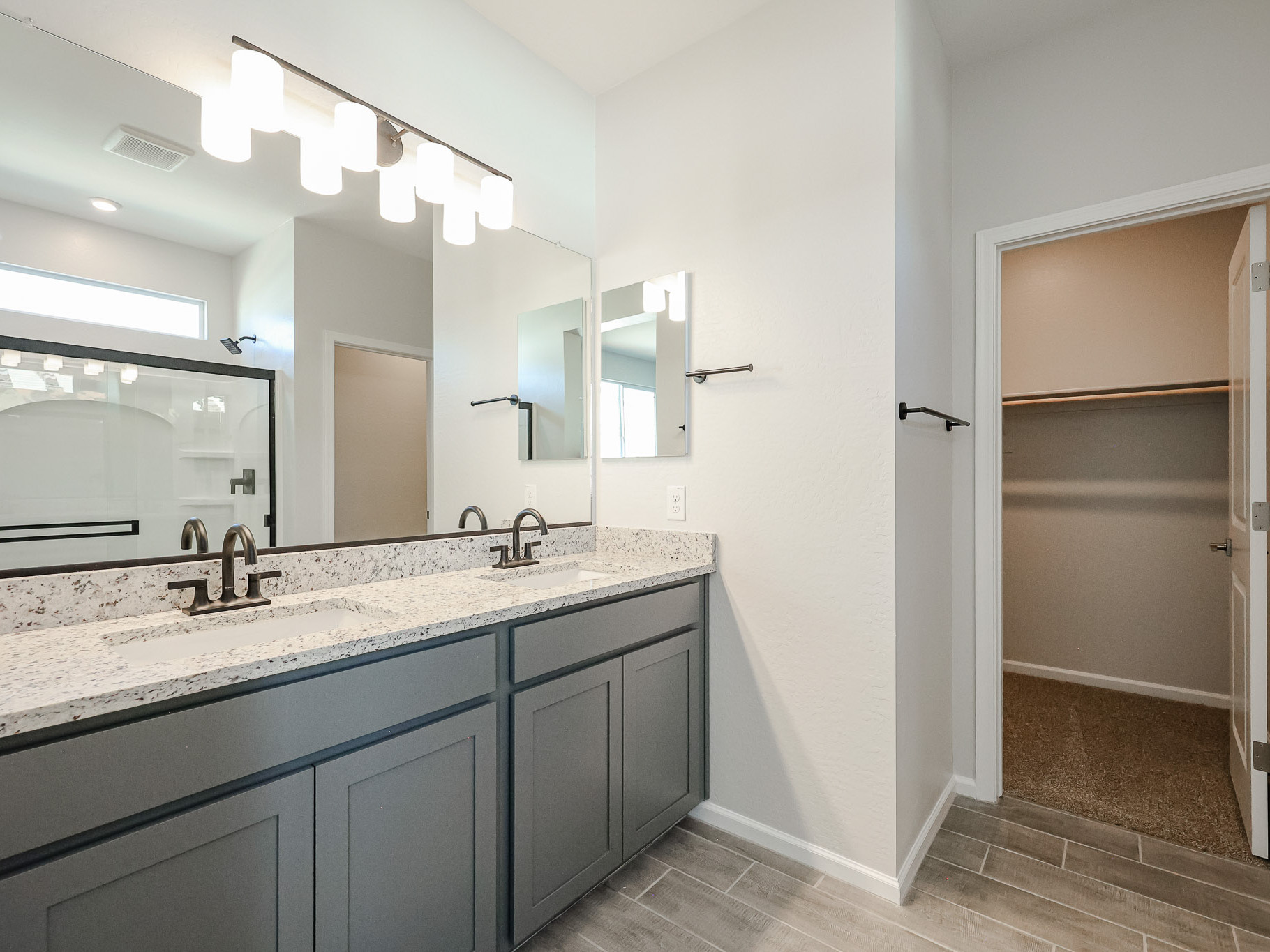 A bathroom with a large mirror.