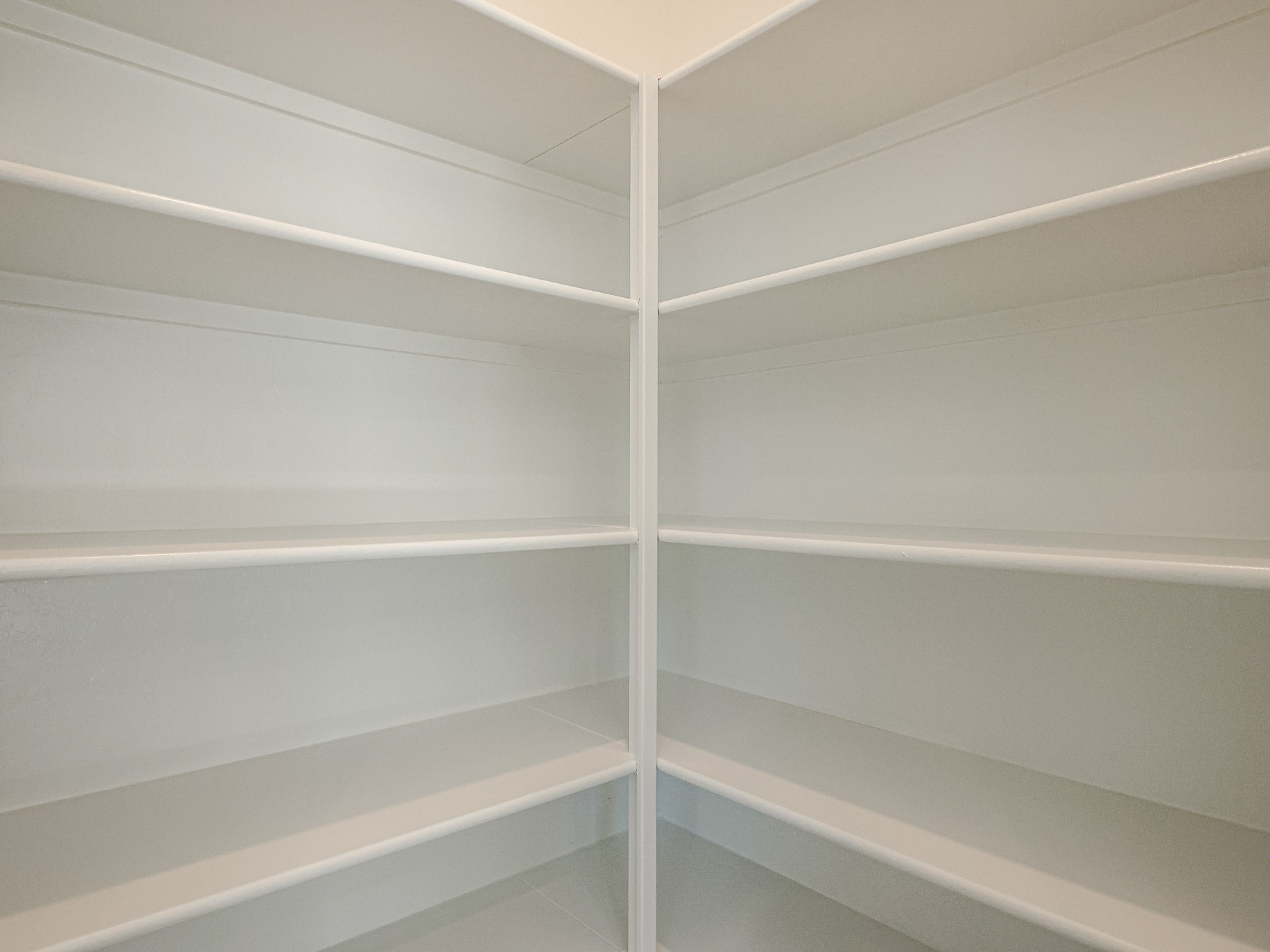 A white wall with a white railing.