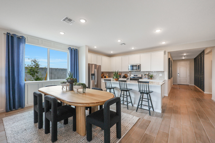 A kitchen with a dining table.