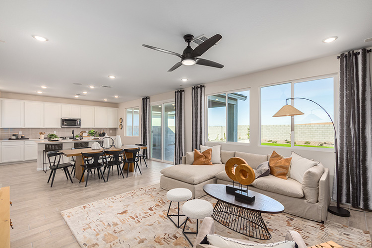 A living room with a large chandelier and a large window.