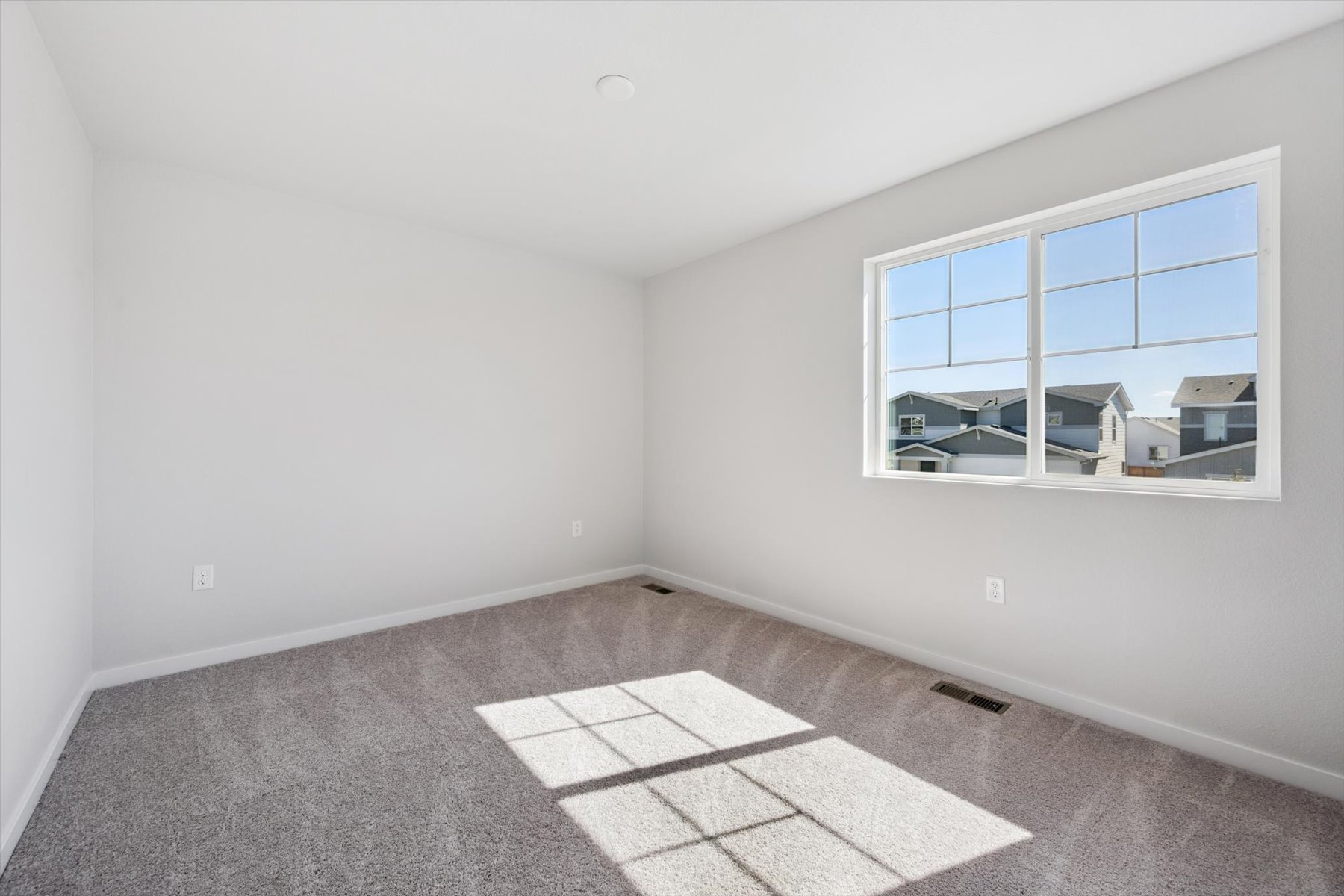 A room with a window and a tile floor.