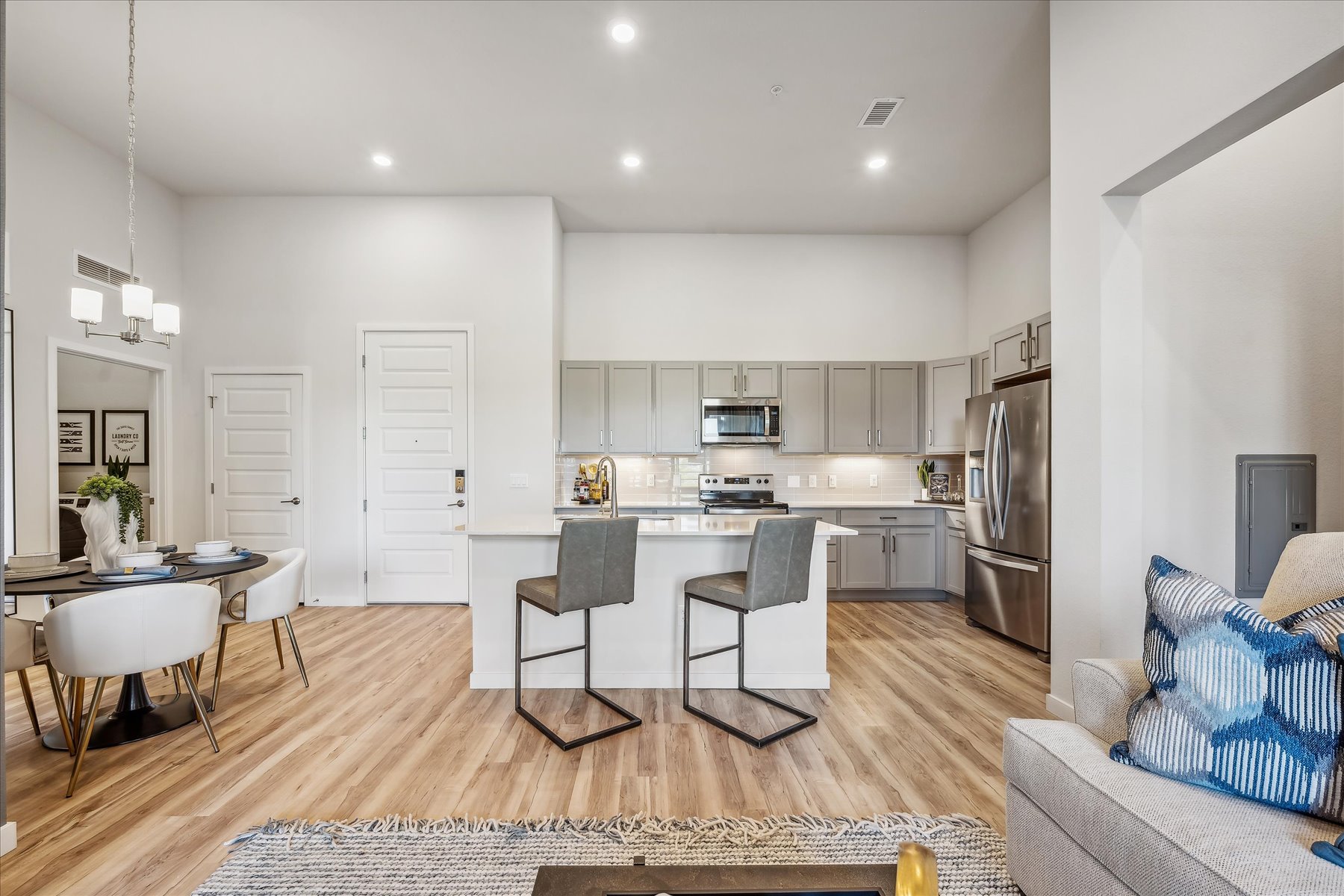 A kitchen with a dining table and chairs.