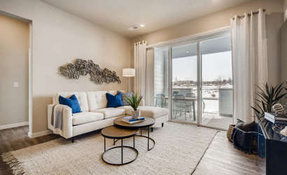 A living room with a large glass door.