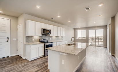 A kitchen with white cabinets.