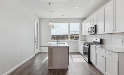 A kitchen with white cabinets.
