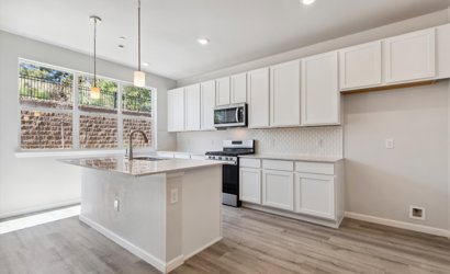 A kitchen with white cabinets.