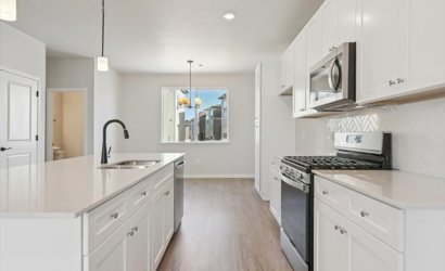 A kitchen with white cabinets.