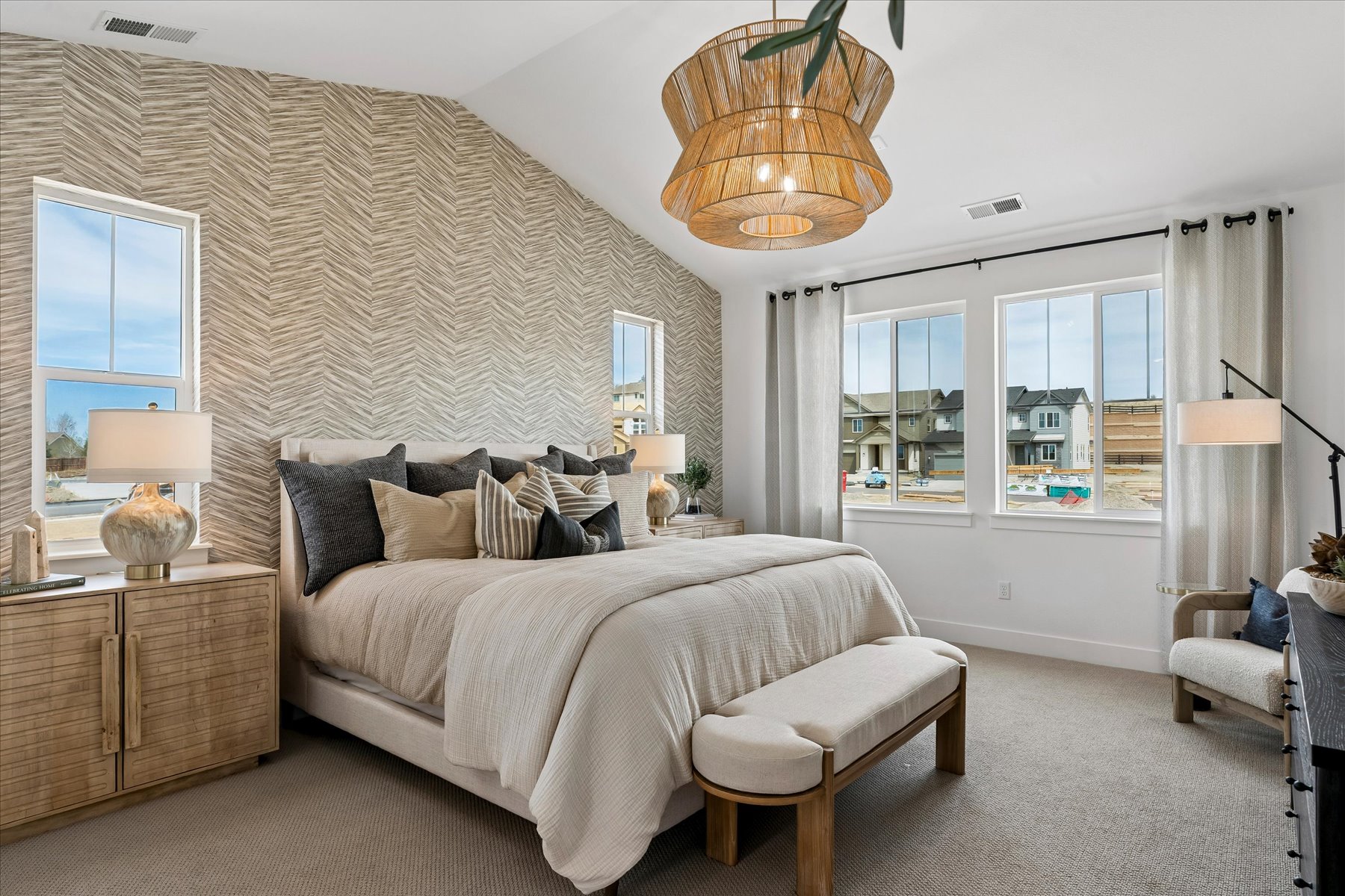 A bedroom with a bed and a chandelier.