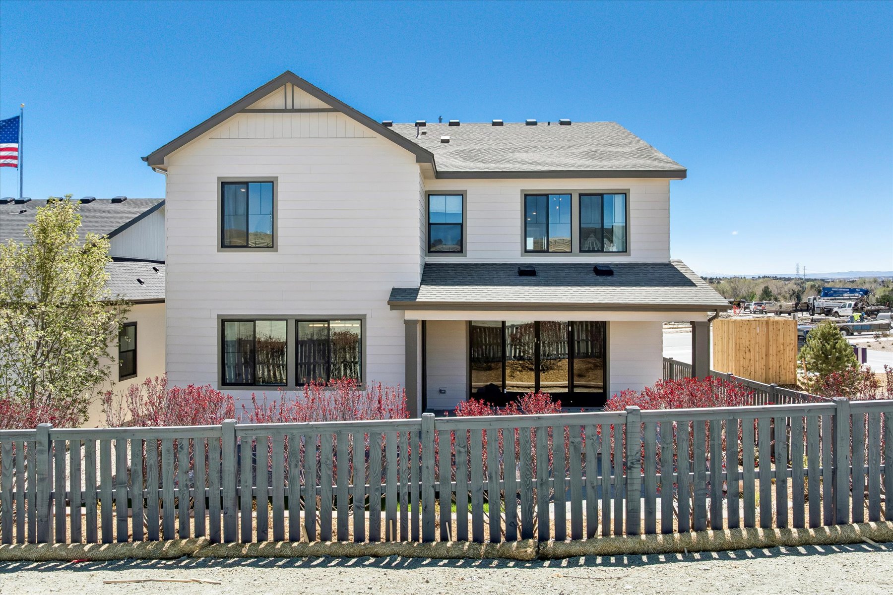 A house with a fence in front.