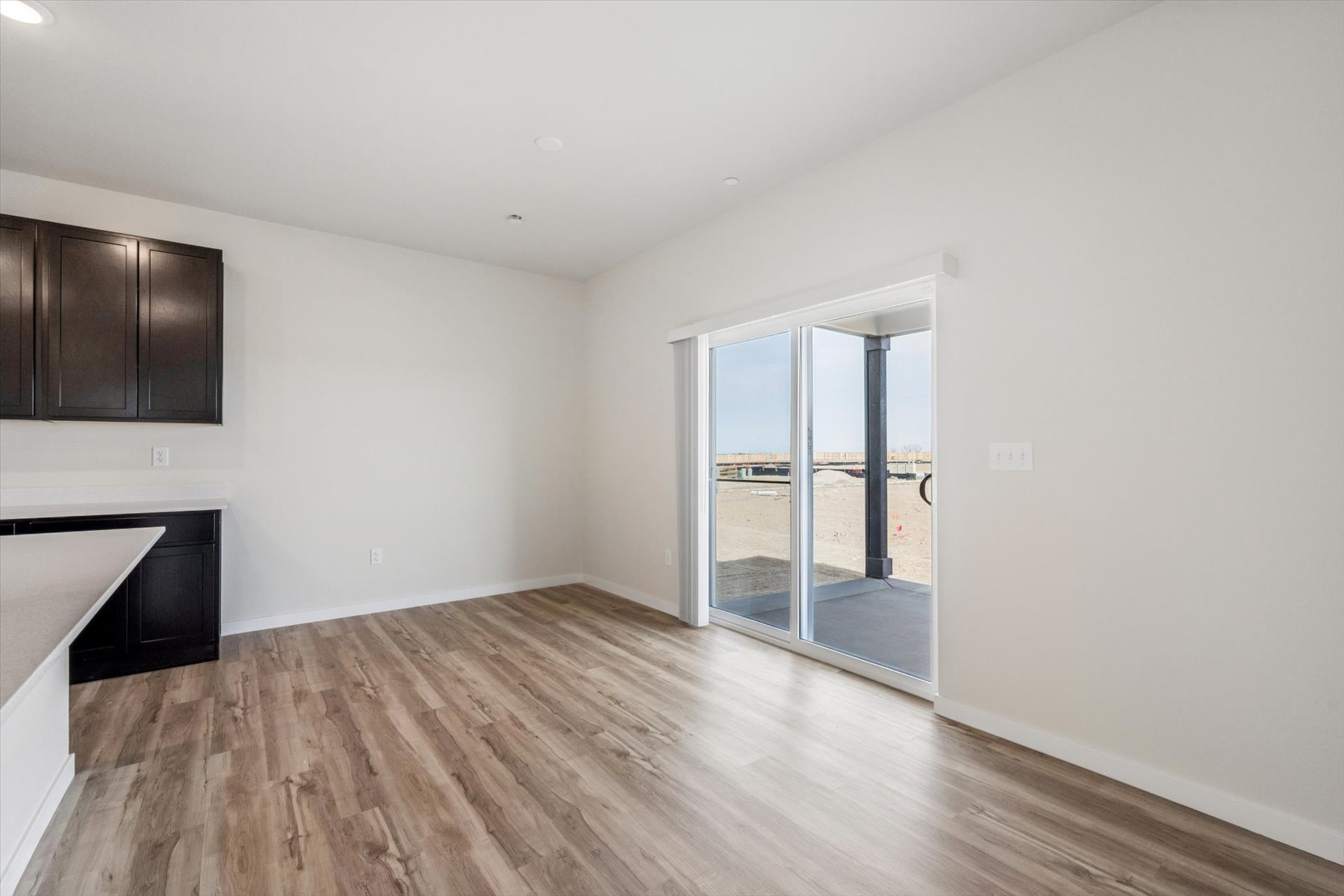 A room with a wood floor and a glass door.