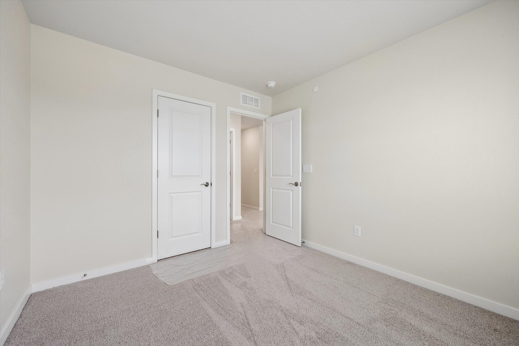 A hallway with white doors.