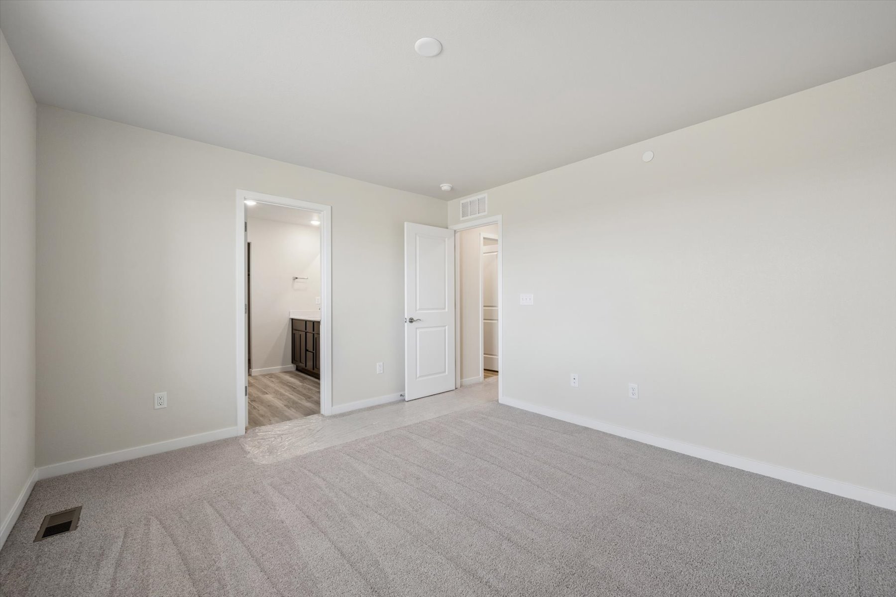 A hallway with white walls.