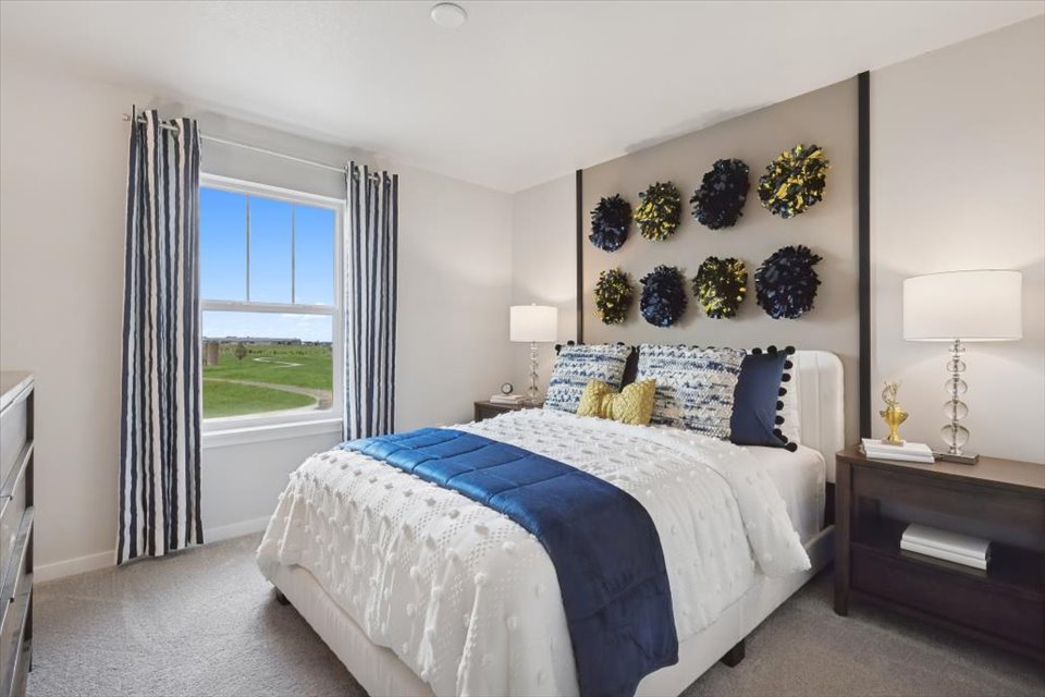 A bedroom with a large window.