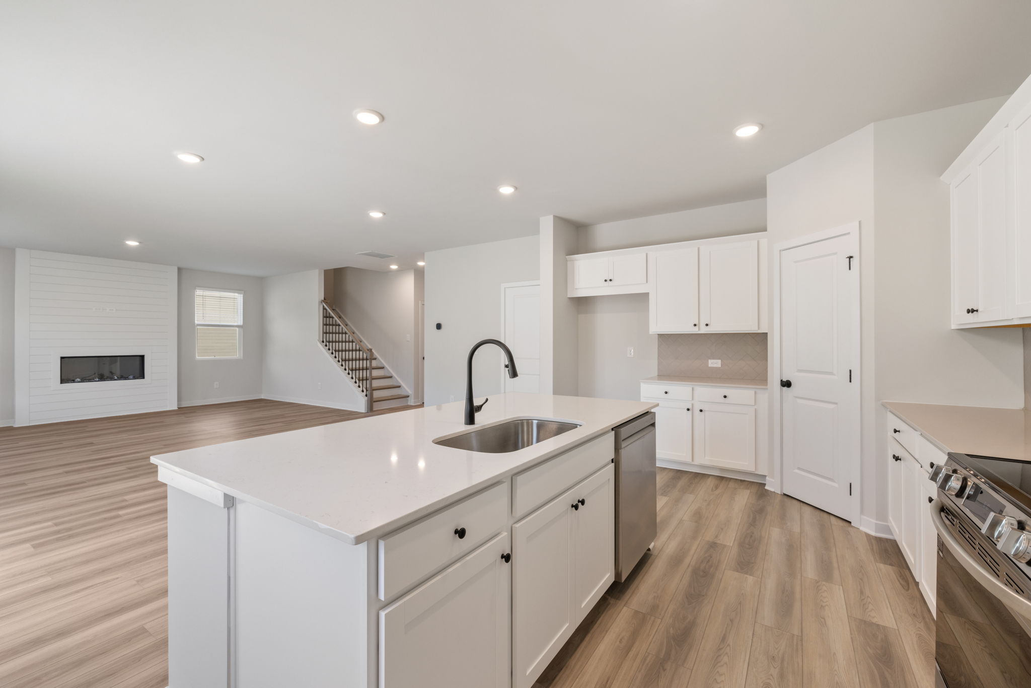 A kitchen with white cabinets.