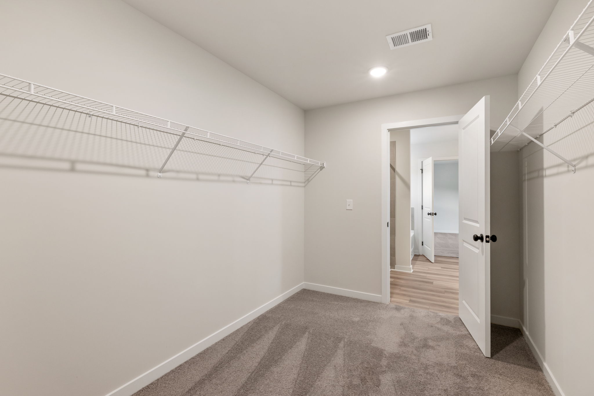 A hallway with white walls.