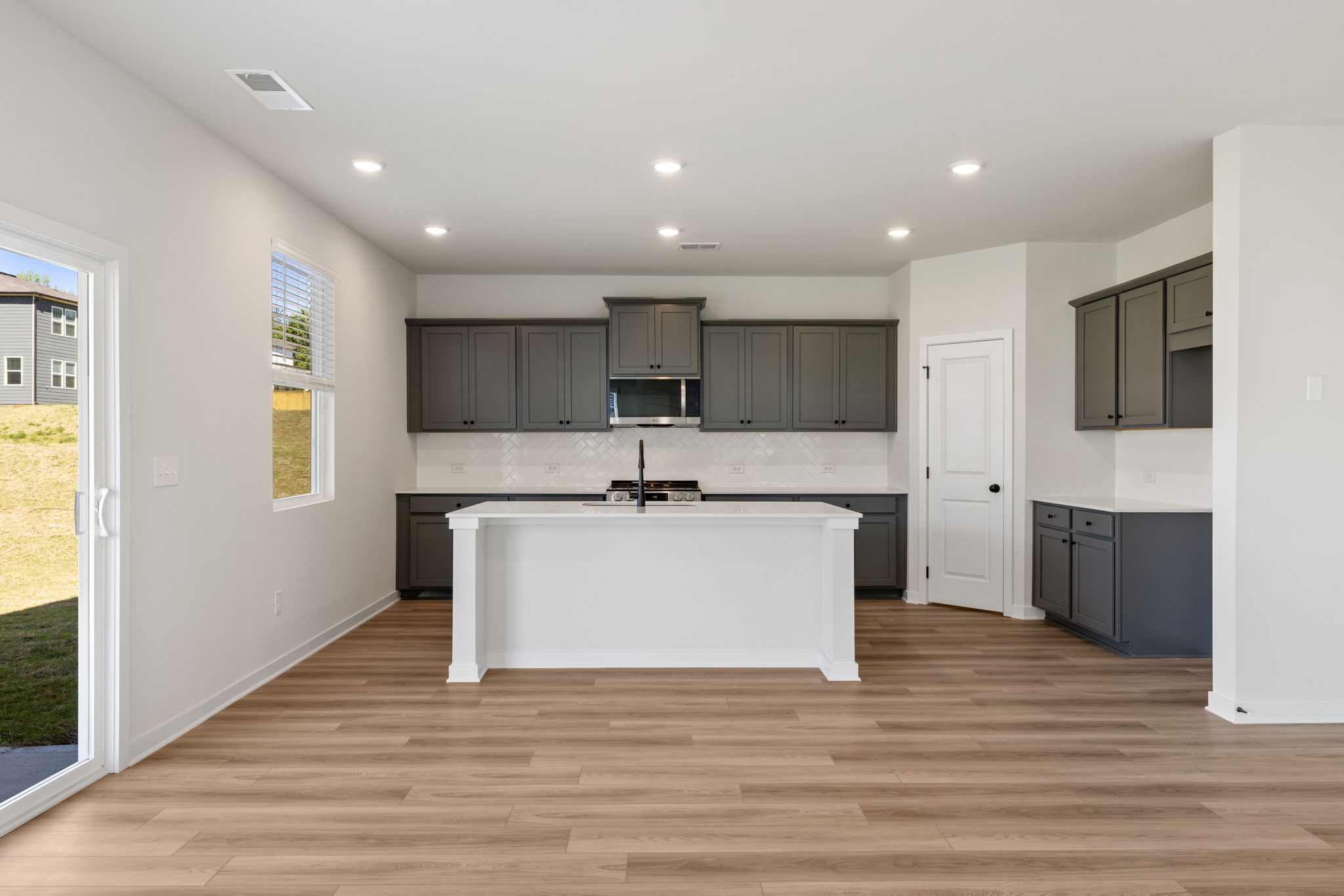 A kitchen with a large white island.