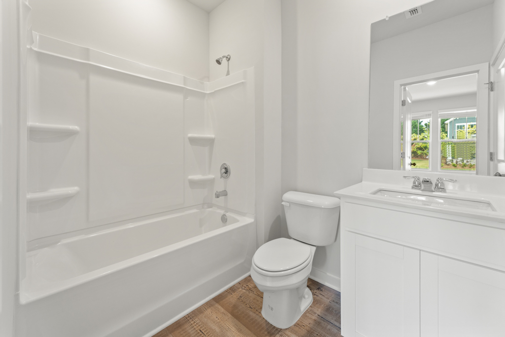 A bathroom with a tub toilet and sink.