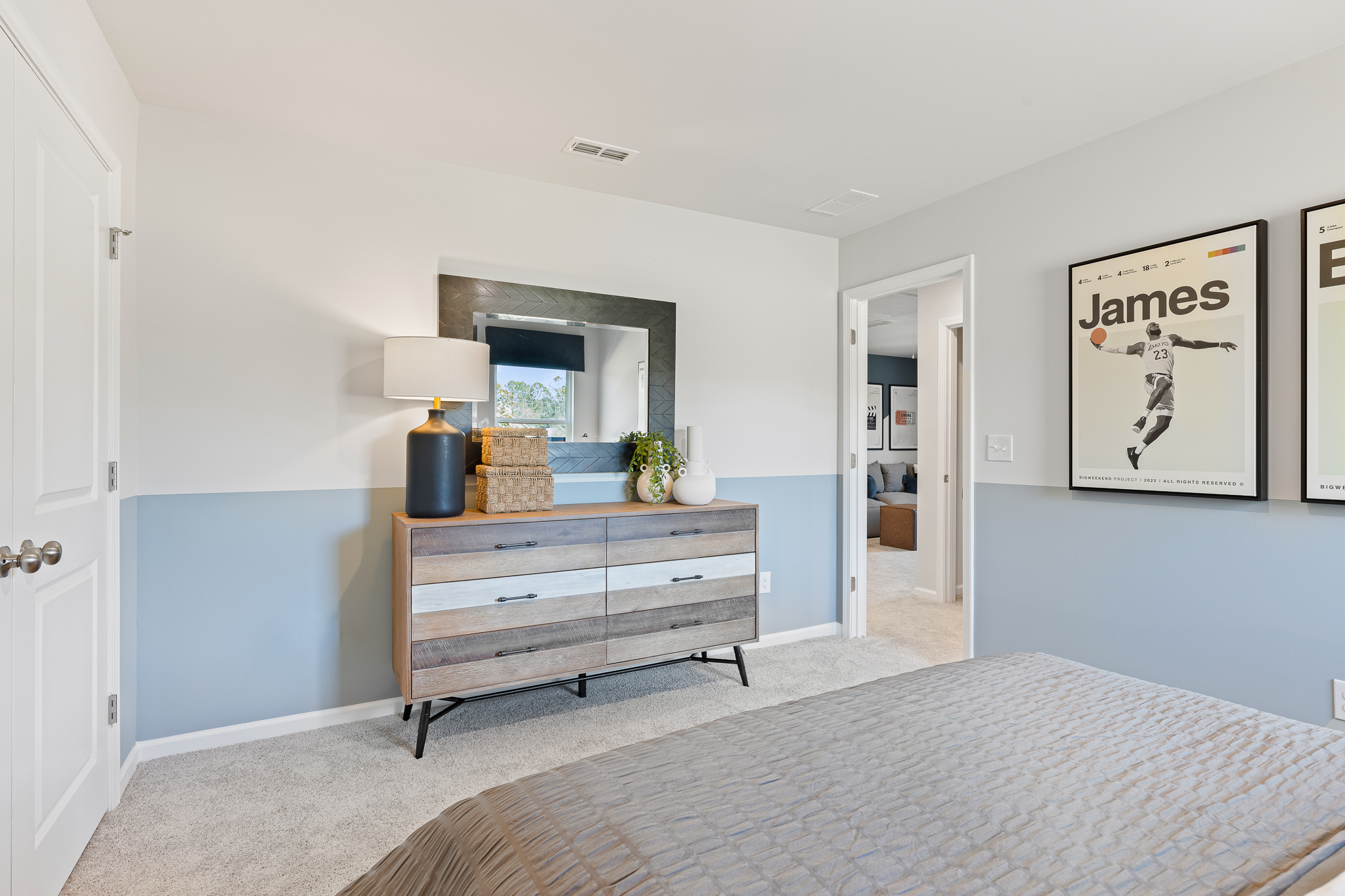 A room with a bed and a bench.