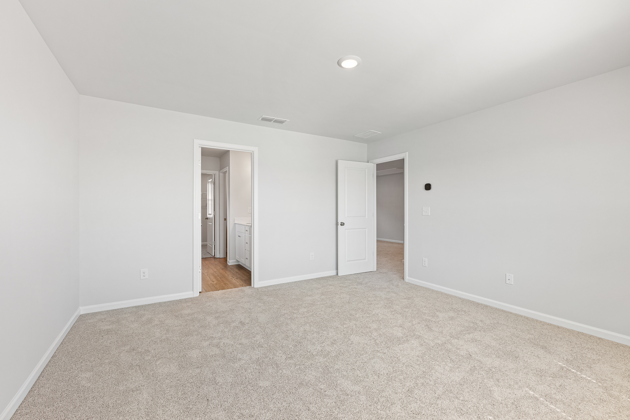 A hallway with white walls.