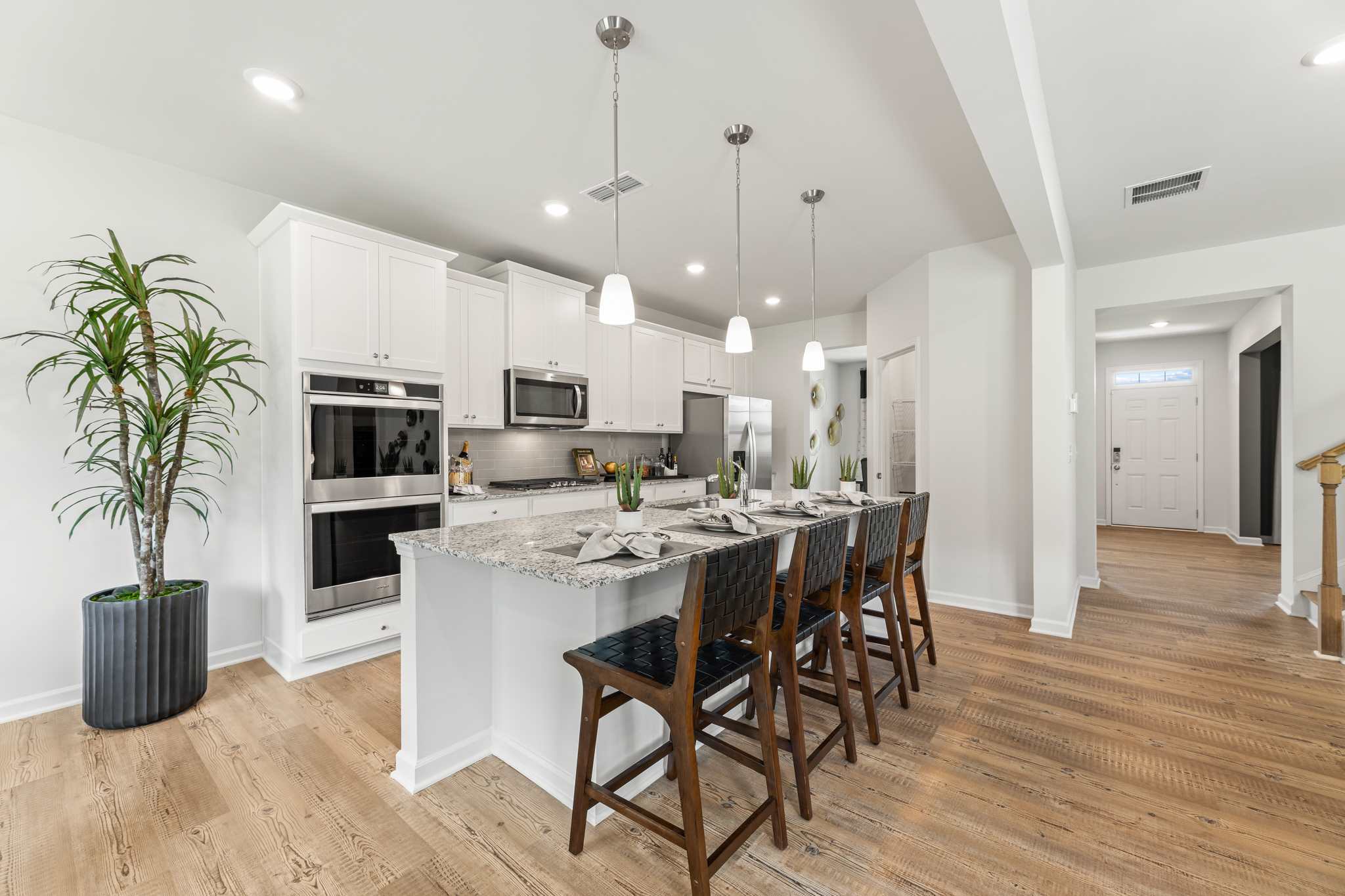 A kitchen with a dining table and chairs.
