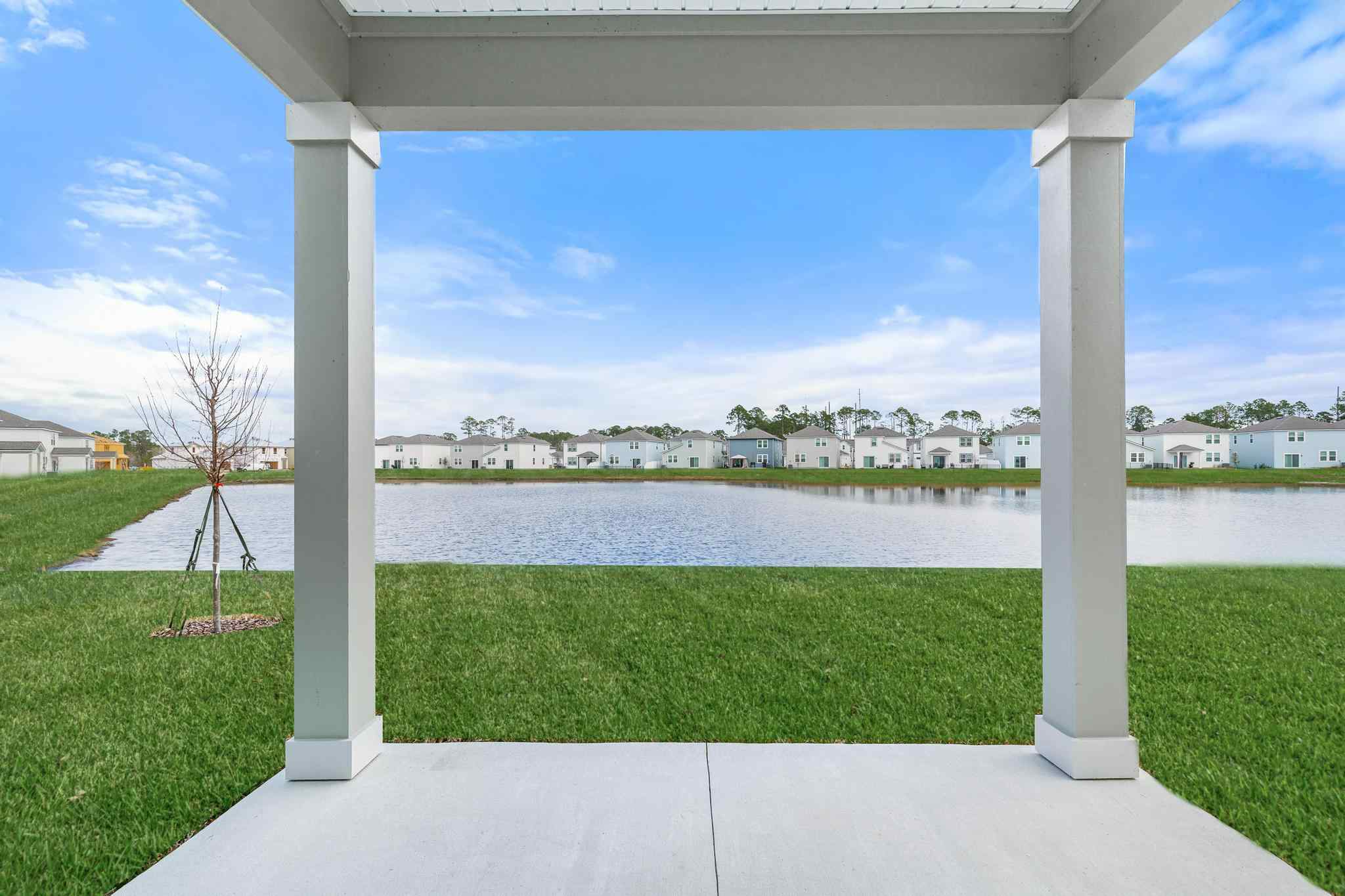 A view of a lake and a town from a balcony.