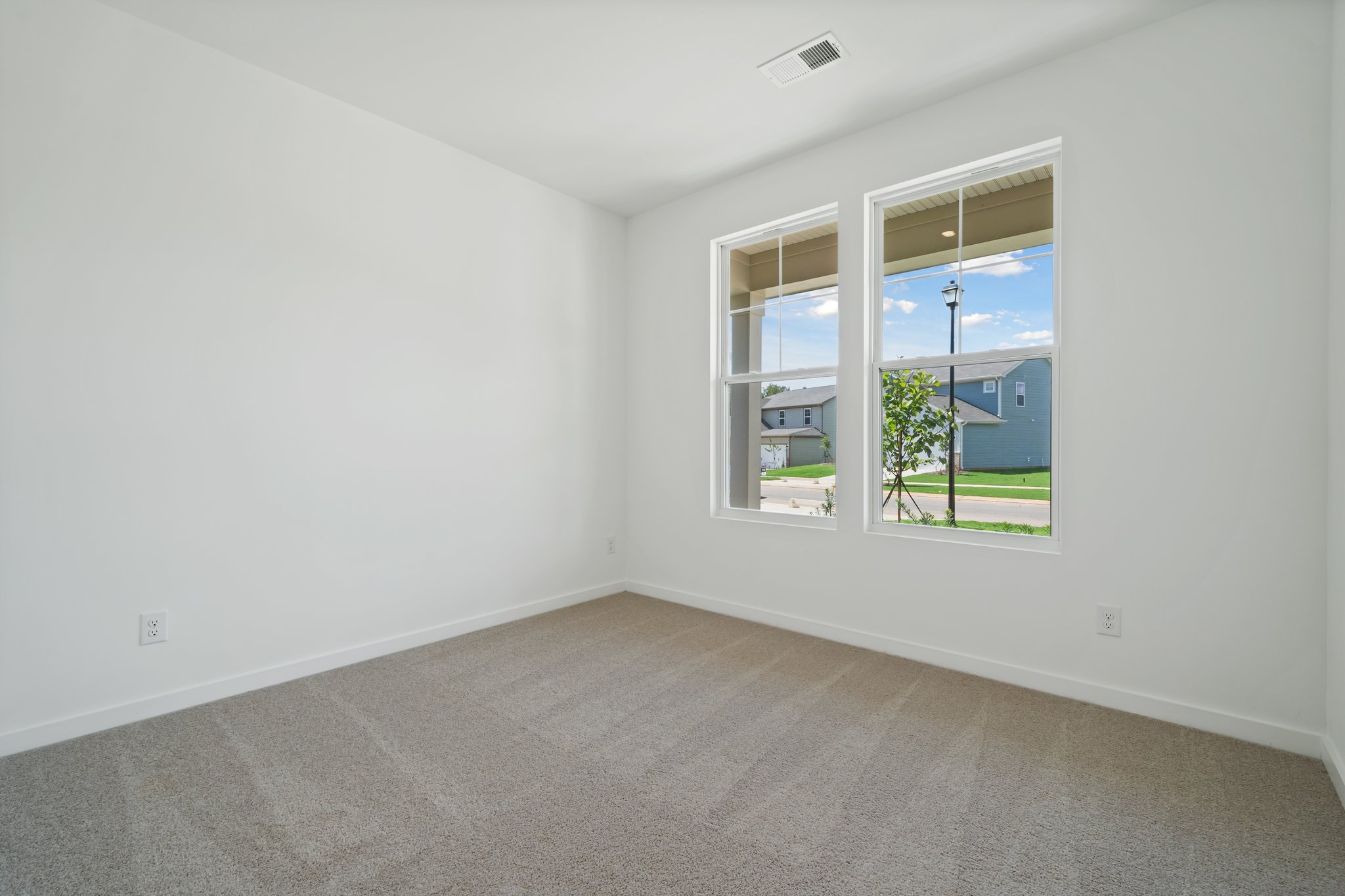 A room with a window and a door with a view of the water.