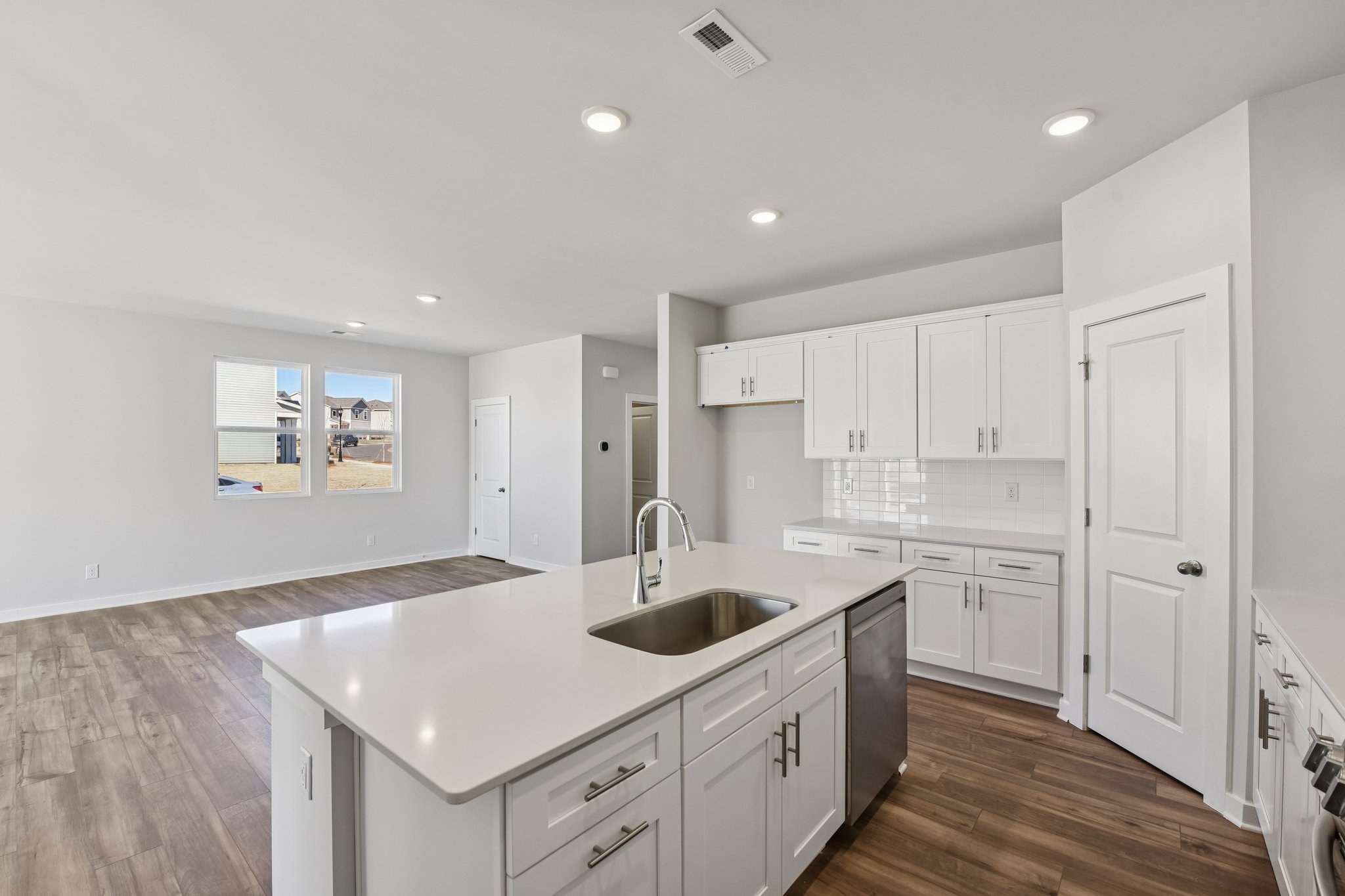 A kitchen with white cabinets.