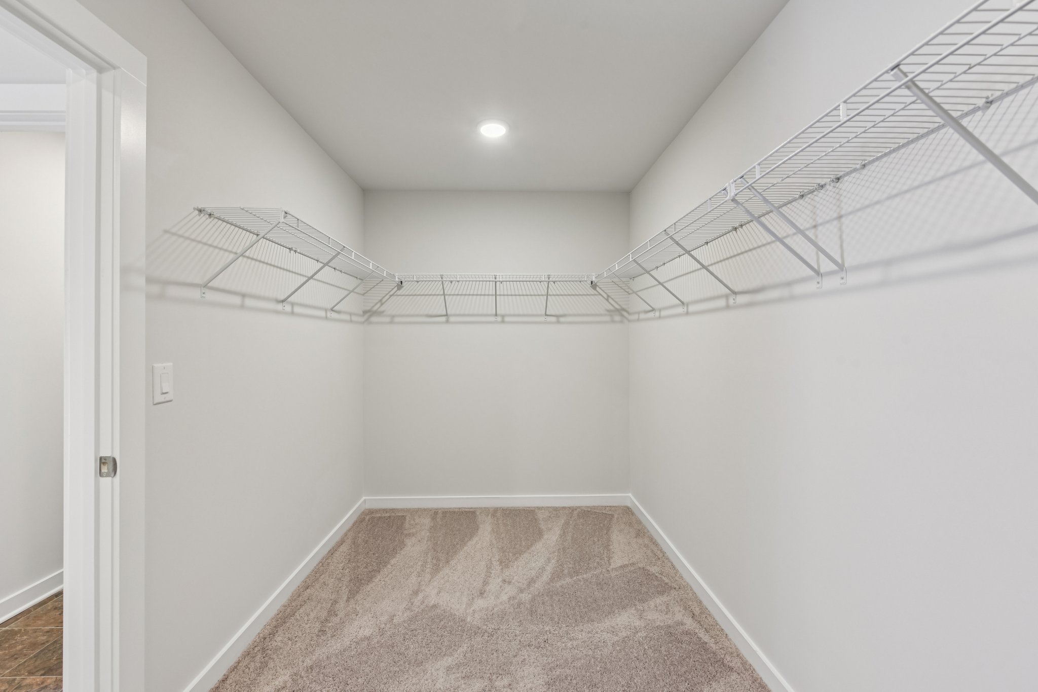 A hallway with white walls.