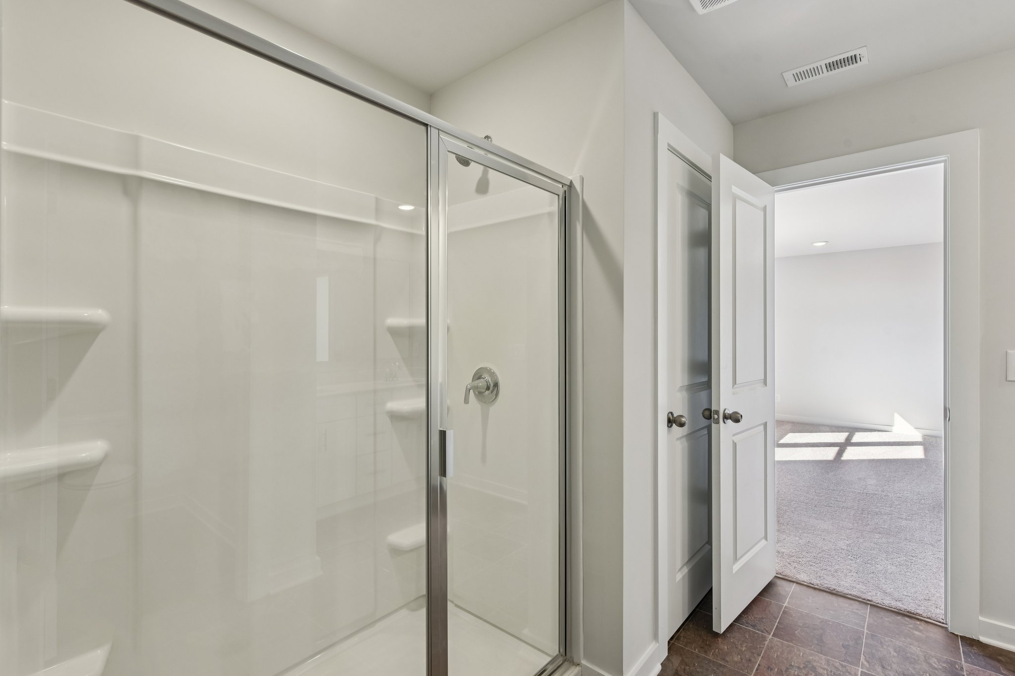 A bathroom with glass doors.