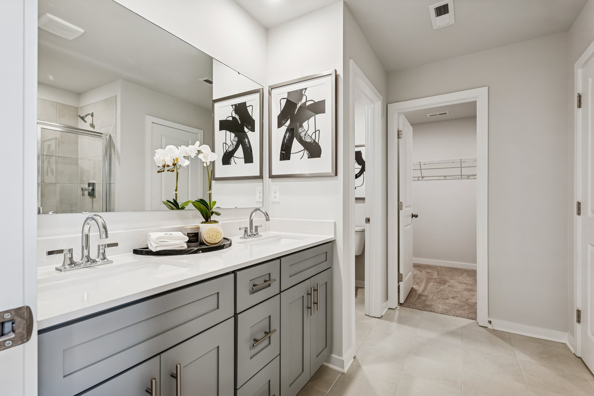 A bathroom with a large mirror.