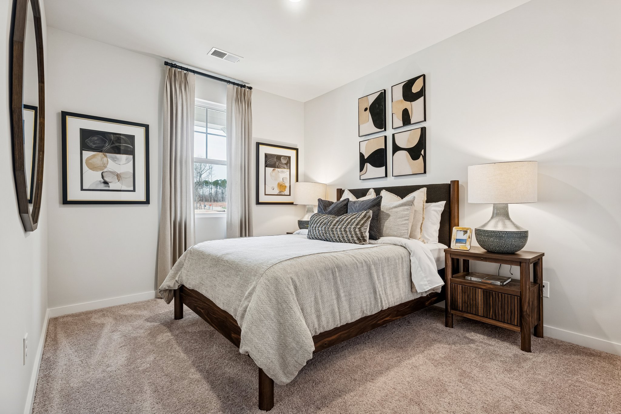 A bedroom with a bed and a lamp.