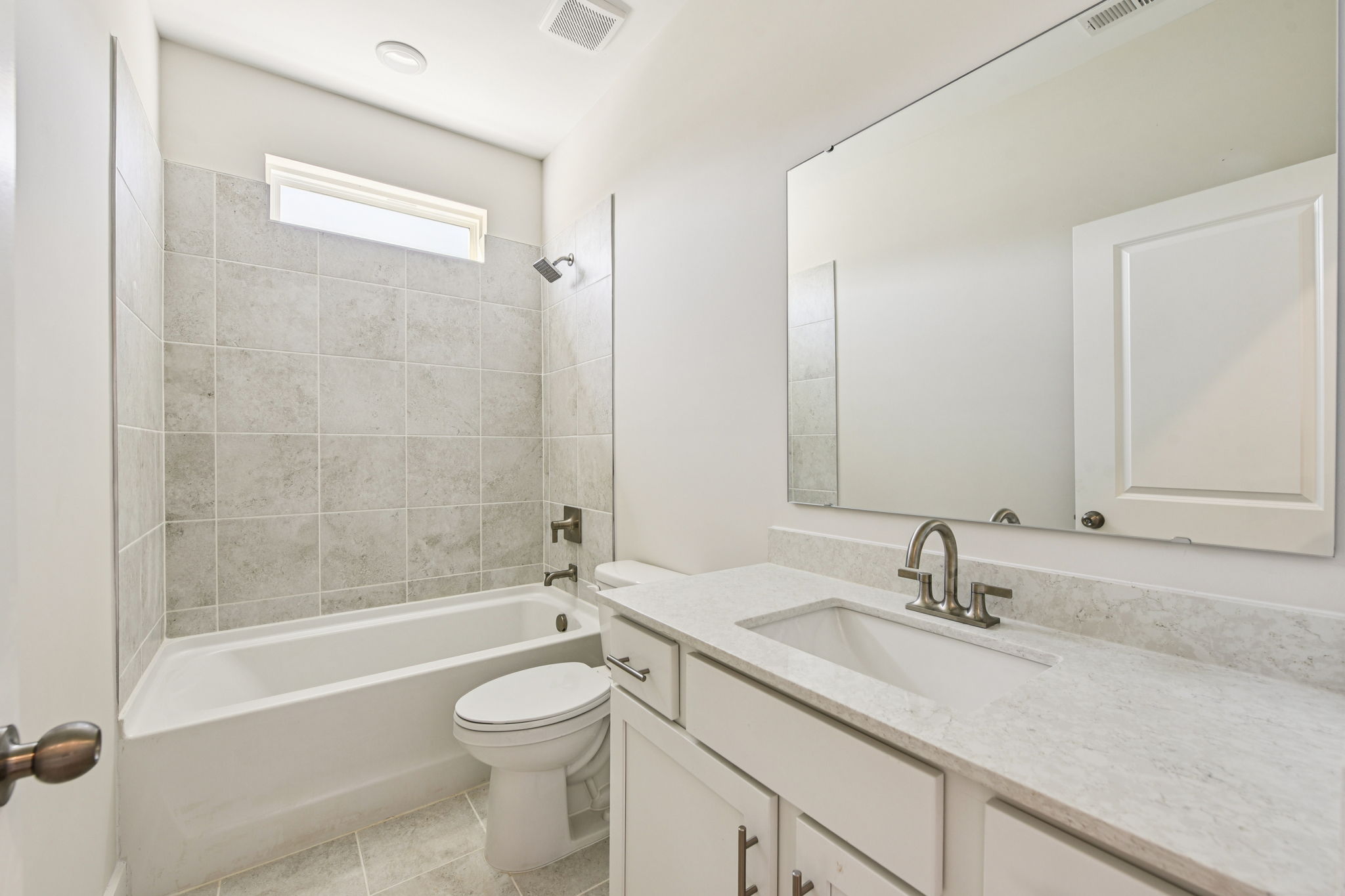 A bathroom with a tub sink and toilet.